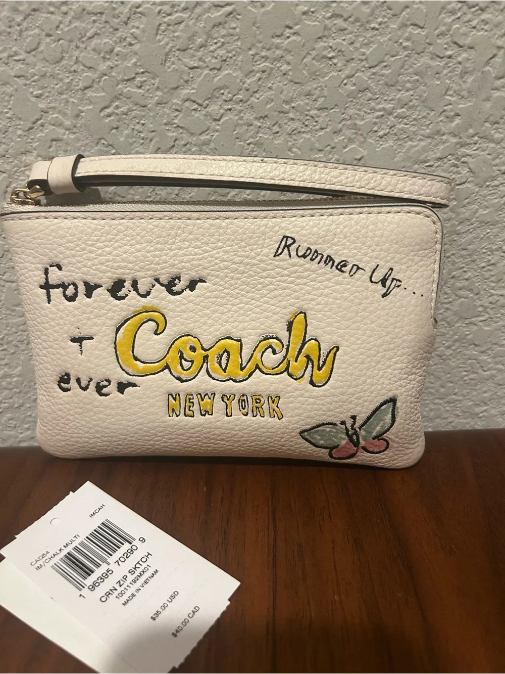Coach White Zip Sketch Wristlet with Yellow Logo and Butterfly Accent